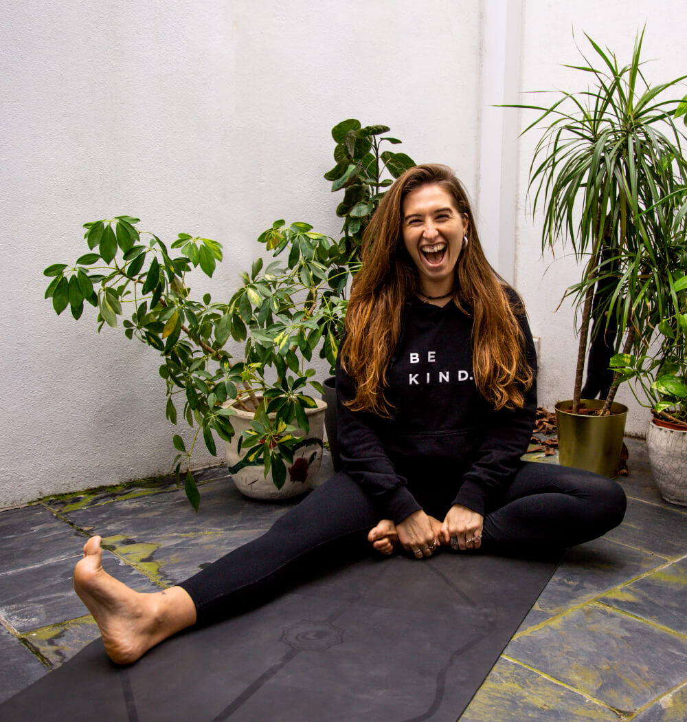 Yoga teacher Aimee Warren on Yoga mat laughing